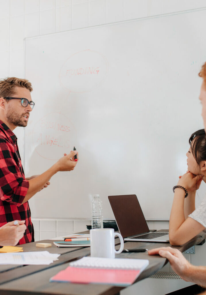 Executive explaining business plans to his coworkers executive explaining business plans to his coworkers